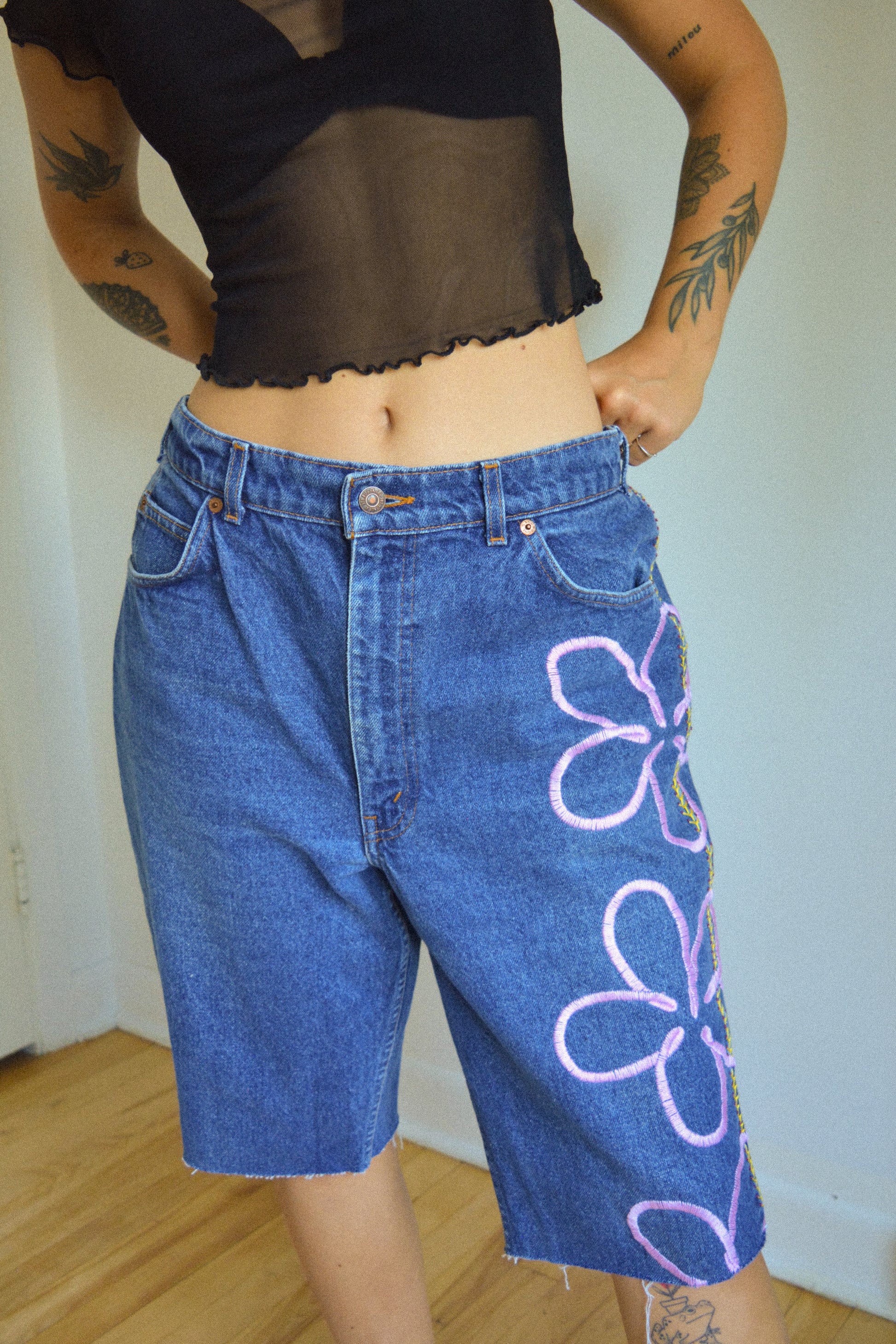 Short vintage en jeans bleu à fleurs roses brodées à la main au Québec par l’artiste et designer Caroline Auger