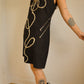 Robe noir vintage en suède avec motif d’une fleur brodé à la main par l’artiste et désigner québécoise Caroline Auger