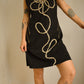 Robe noir vintage en suède avec motif d’une fleur brodé à la main par l’artiste et désigner québécoise Caroline Auger