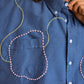 Chemise vintage à manche courte bleu avec billes, laine et lignes abstraites brodées à la main par l’artiste et désigner québécoise Caroline Auger